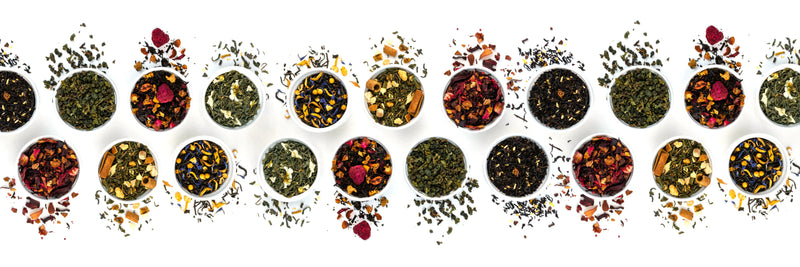 White background with a double horizontal rows of white bowls with acolorful variety of loose leaf teas and herbal blends.